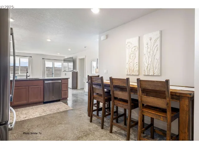 a view of a dining room with furniture and window
