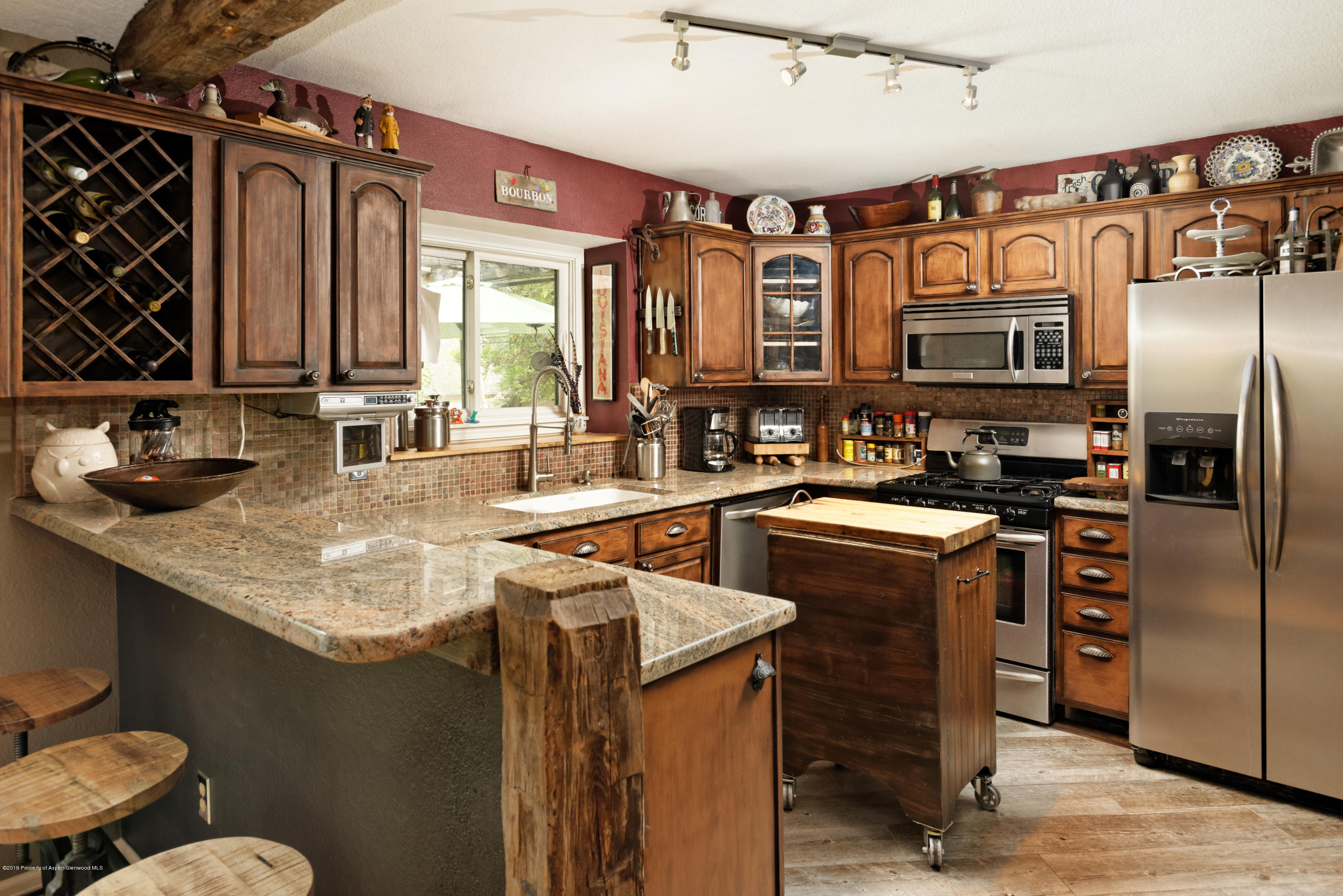 195 Riverside Drive Basalt, CO 81621 - Photo 7 of 38 a kitchen with stainless steel appliances granite countertop a sink stove and refrigerator