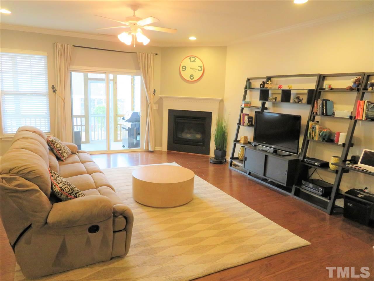 2442 Memory Ridge Drive Raleigh, NC 27606 - Photo 2 of 23 a living room with furniture a flat screen tv and a fireplace