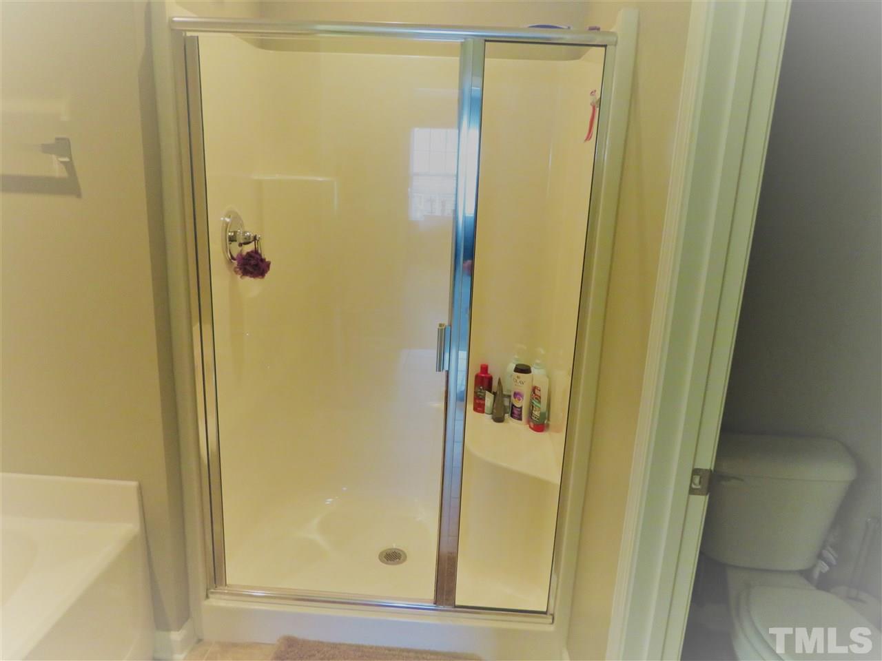 2442 Memory Ridge Drive Raleigh, NC 27606 - Photo 11 of 23 a bathroom with a glass shower door