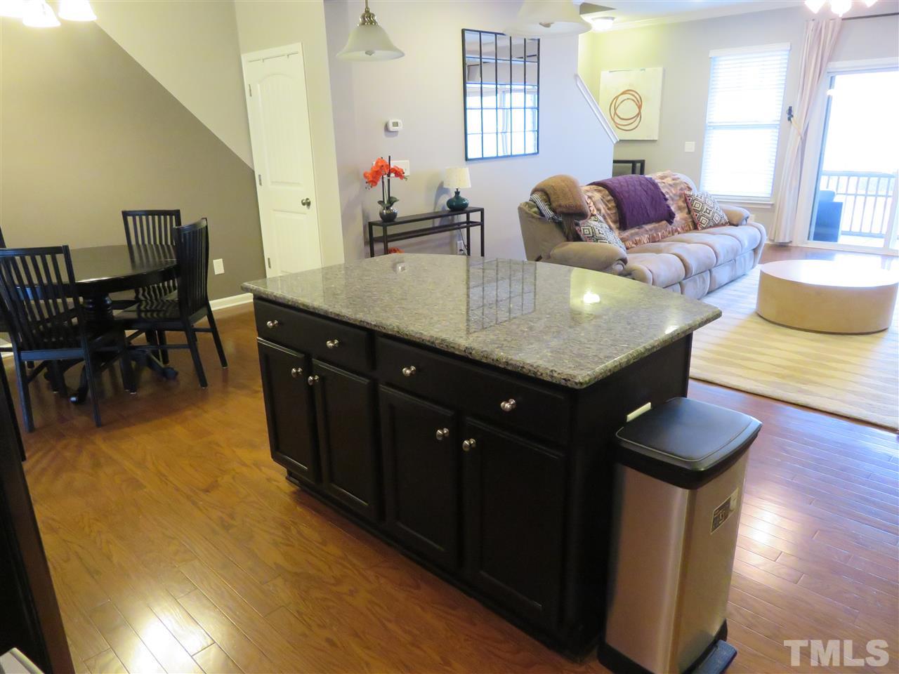 2442 Memory Ridge Drive Raleigh, NC 27606 - Photo 14 of 23 a living room with kitchen island furniture and a wooden floor