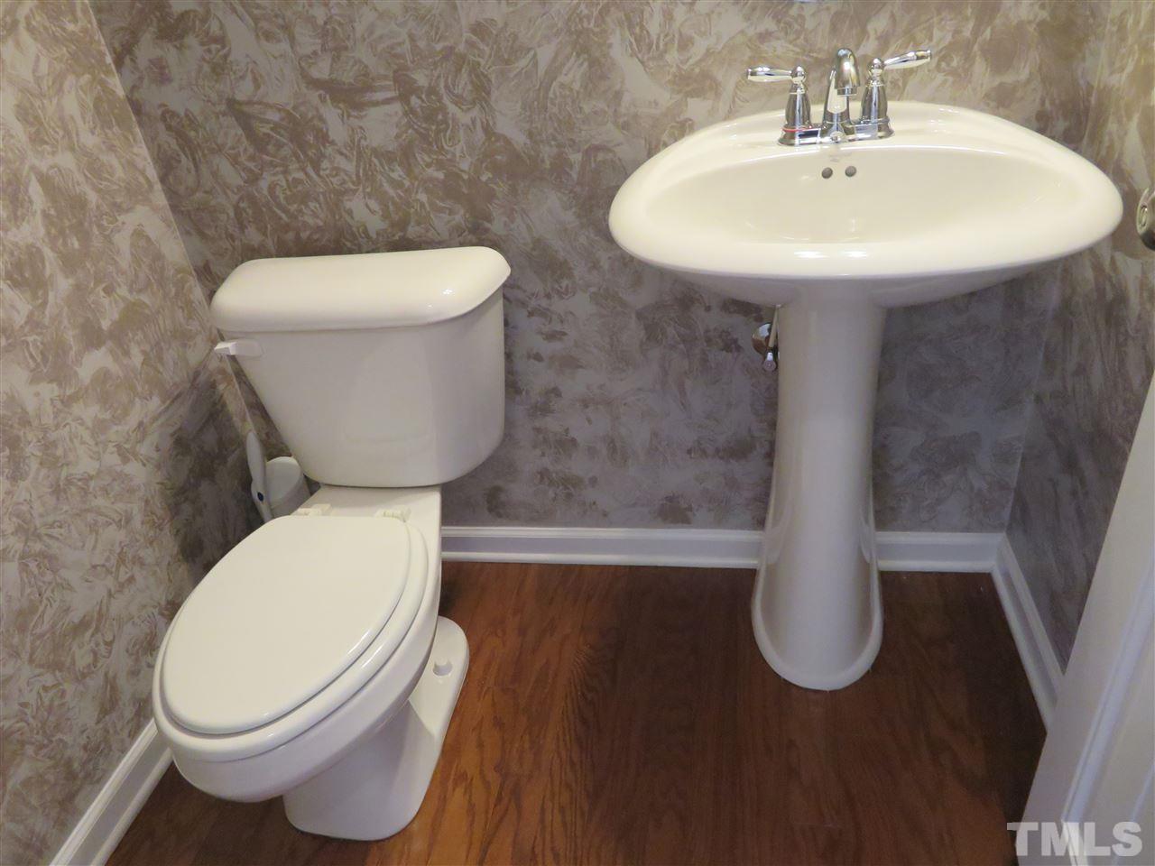 2442 Memory Ridge Drive Raleigh, NC 27606 - Photo 15 of 23 a white toilet sitting next to a bathroom sink
