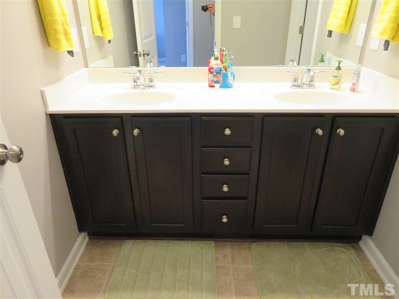 2442 Memory Ridge Drive Raleigh, NC 27606 - Photo 21 of 23 a bathroom with a sink vanity and a mirror