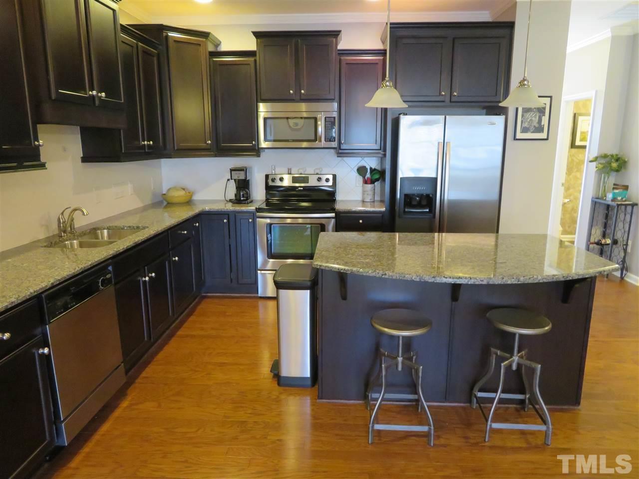 2442 Memory Ridge Drive Raleigh, NC 27606 - Photo 4 of 23 a kitchen with stainless steel appliances granite countertop a sink counter space and cabinets