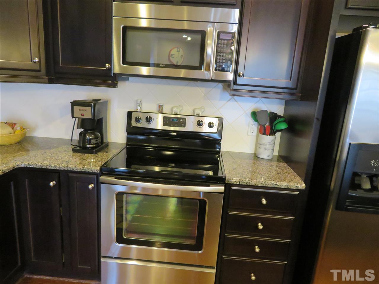 2442 Memory Ridge Drive Raleigh, NC 27606 - Photo 7 of 23 a kitchen with granite countertop stainless steel appliances and cabinets
