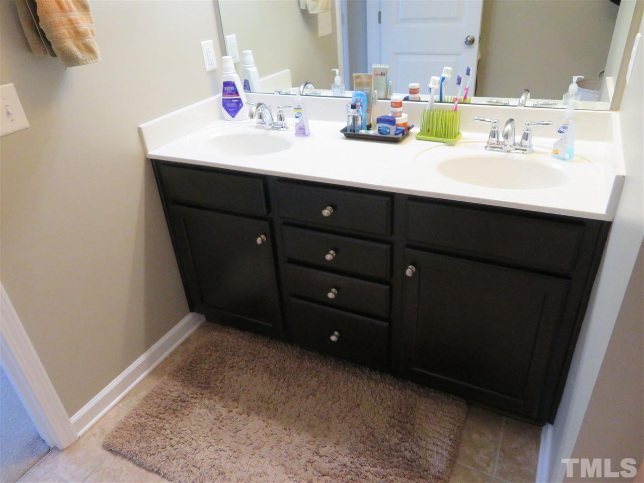 2442 Memory Ridge Drive Raleigh, NC 27606 - Photo 9 of 23 a bathroom with a sink and a mirror