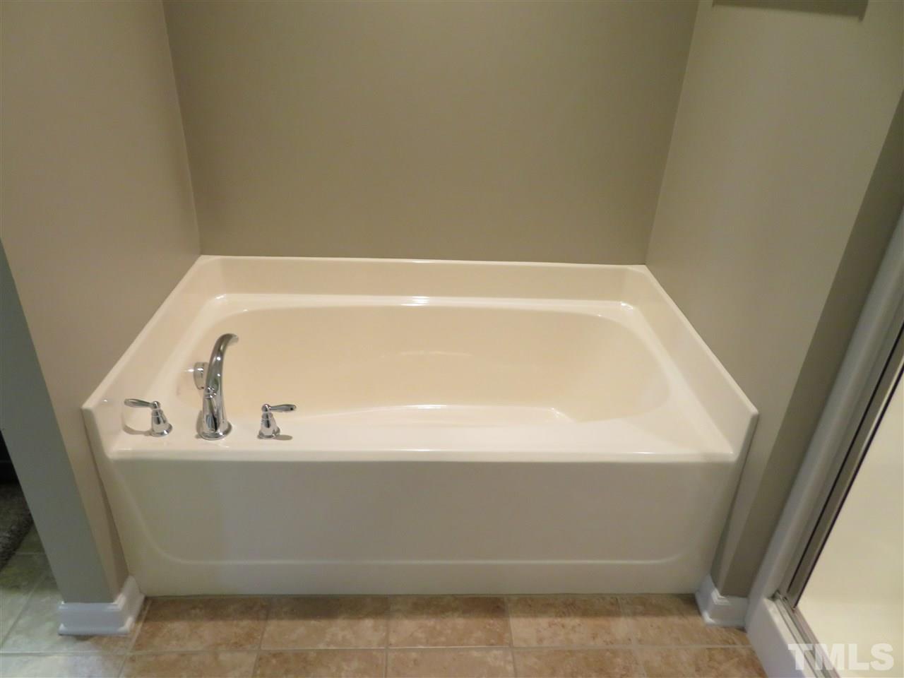 2442 Memory Ridge Drive Raleigh, NC 27606 - Photo 10 of 23 a bathroom with a bathtub