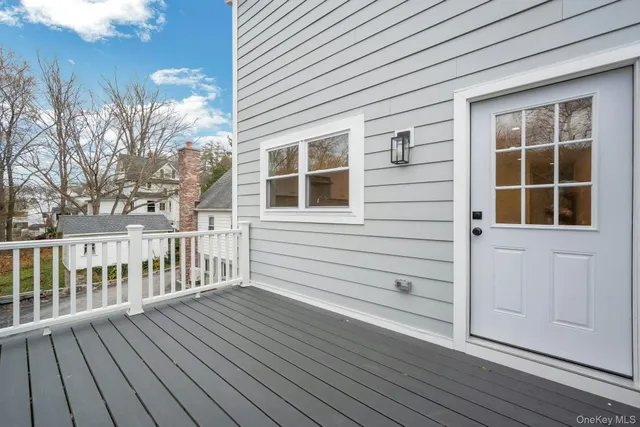 a view of a house with wooden deck