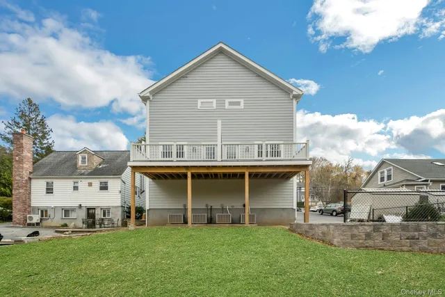 a view of a house with a big yard and large trees
