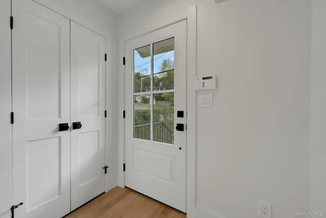 a view of a small space with wooden floor and a window