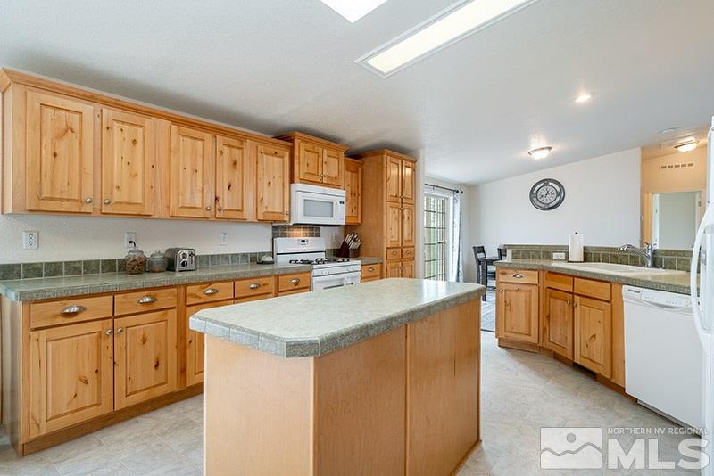 3745 Schindler Road Fallon, NV 89406 - Photo 5 of 16 a large kitchen with granite countertop a sink counter space cabinets and stainless steel appliances