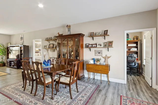 a view of a dining room with furniture and wooden floor
