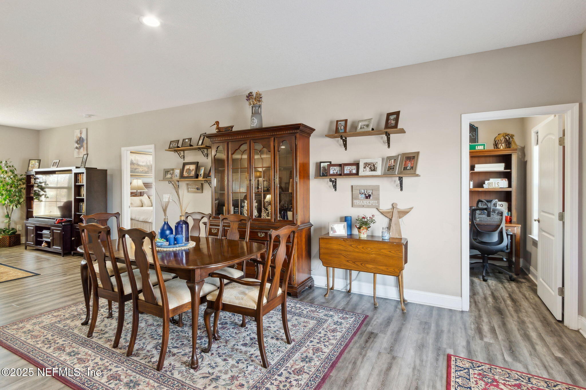 3303 Henry Lee Road Hilliard, FL 32046 - Photo 13 of 35 a view of a dining room with furniture and wooden floor