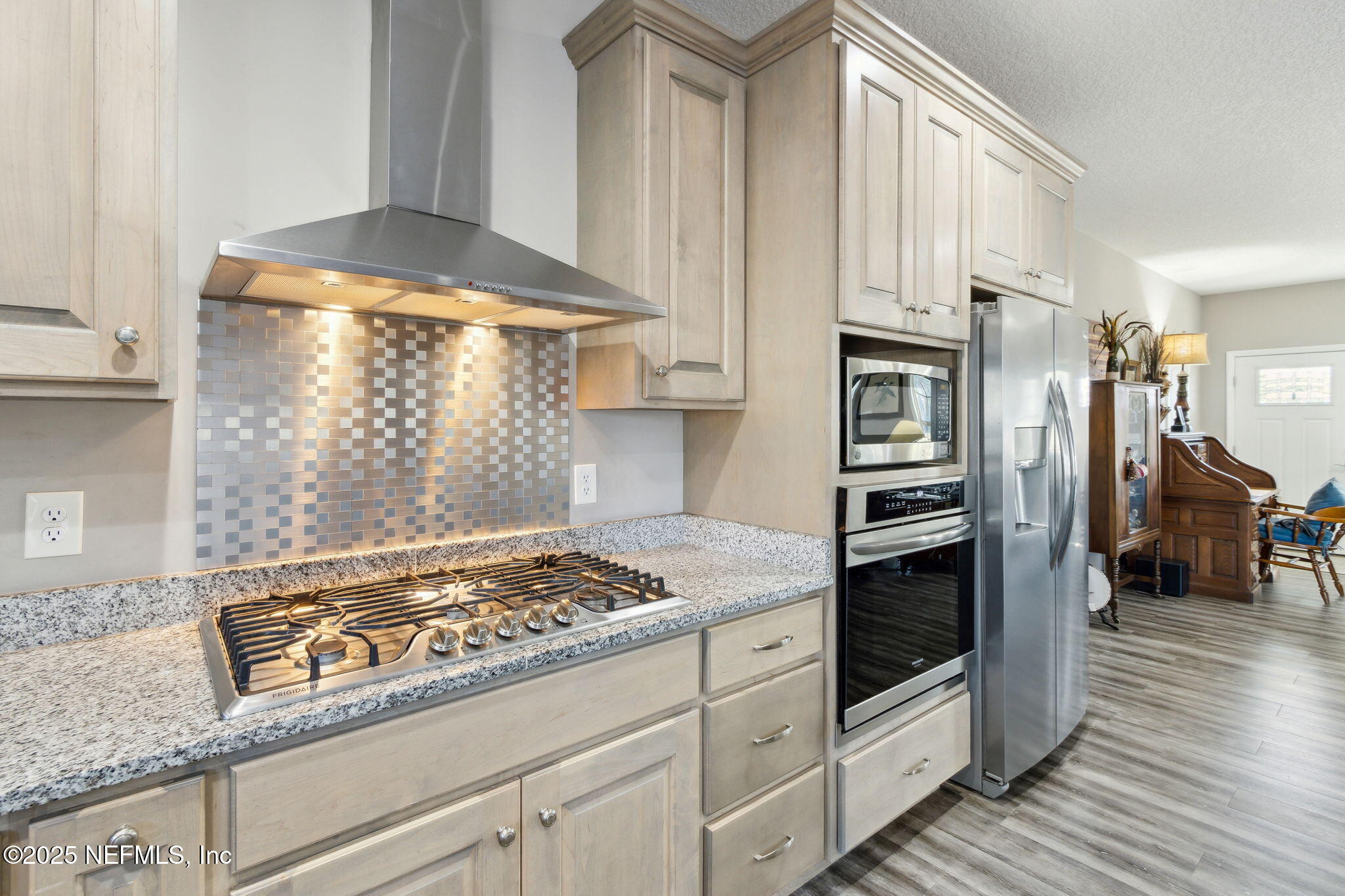 3303 Henry Lee Road Hilliard, FL 32046 - Photo 16 of 35 a kitchen with granite countertop a stove and a refrigerator