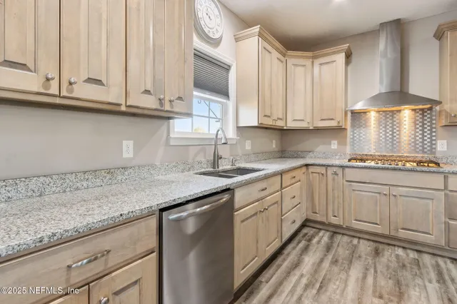 a kitchen with granite countertop white cabinets and white appliances