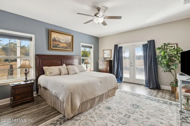 a spacious bedroom with a large bed and a chandelier fan