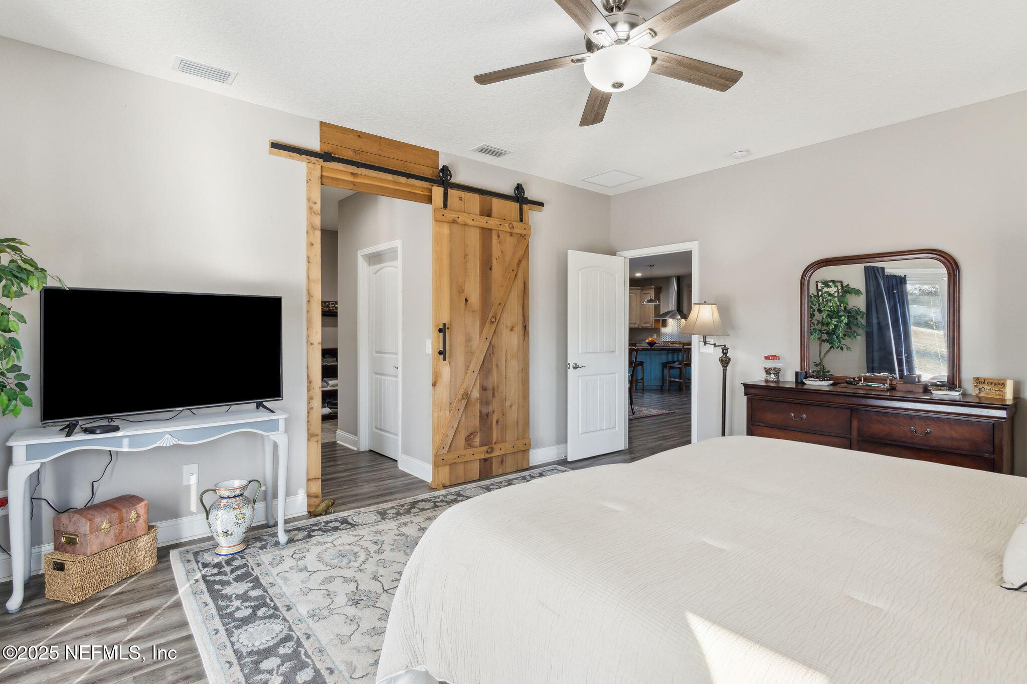 3303 Henry Lee Road Hilliard, FL 32046 - Photo 21 of 35 a bedroom with a bed and a flat screen tv