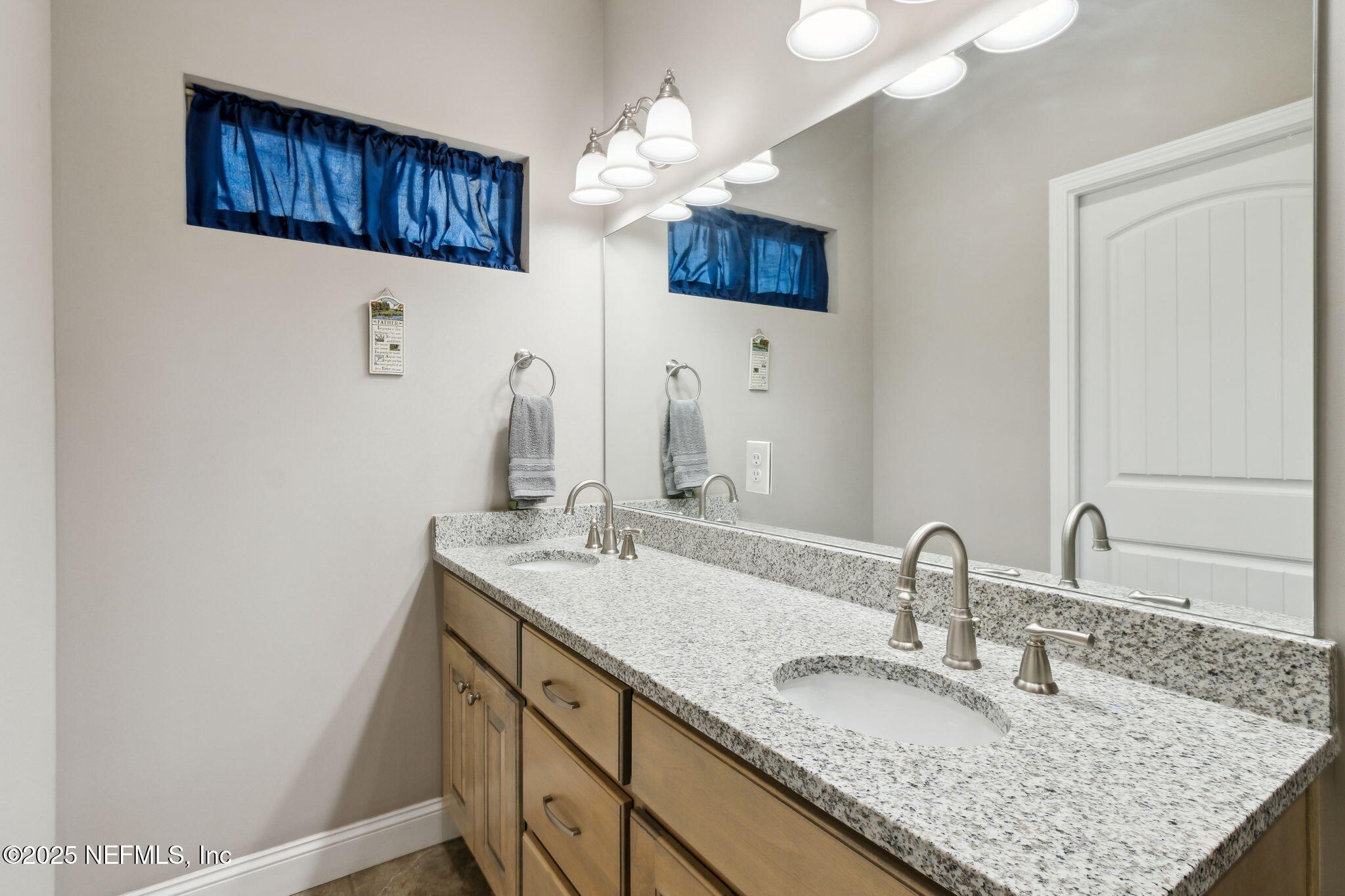 3303 Henry Lee Road Hilliard, FL 32046 - Photo 22 of 35 a bathroom with a sink double vanity and a mirror