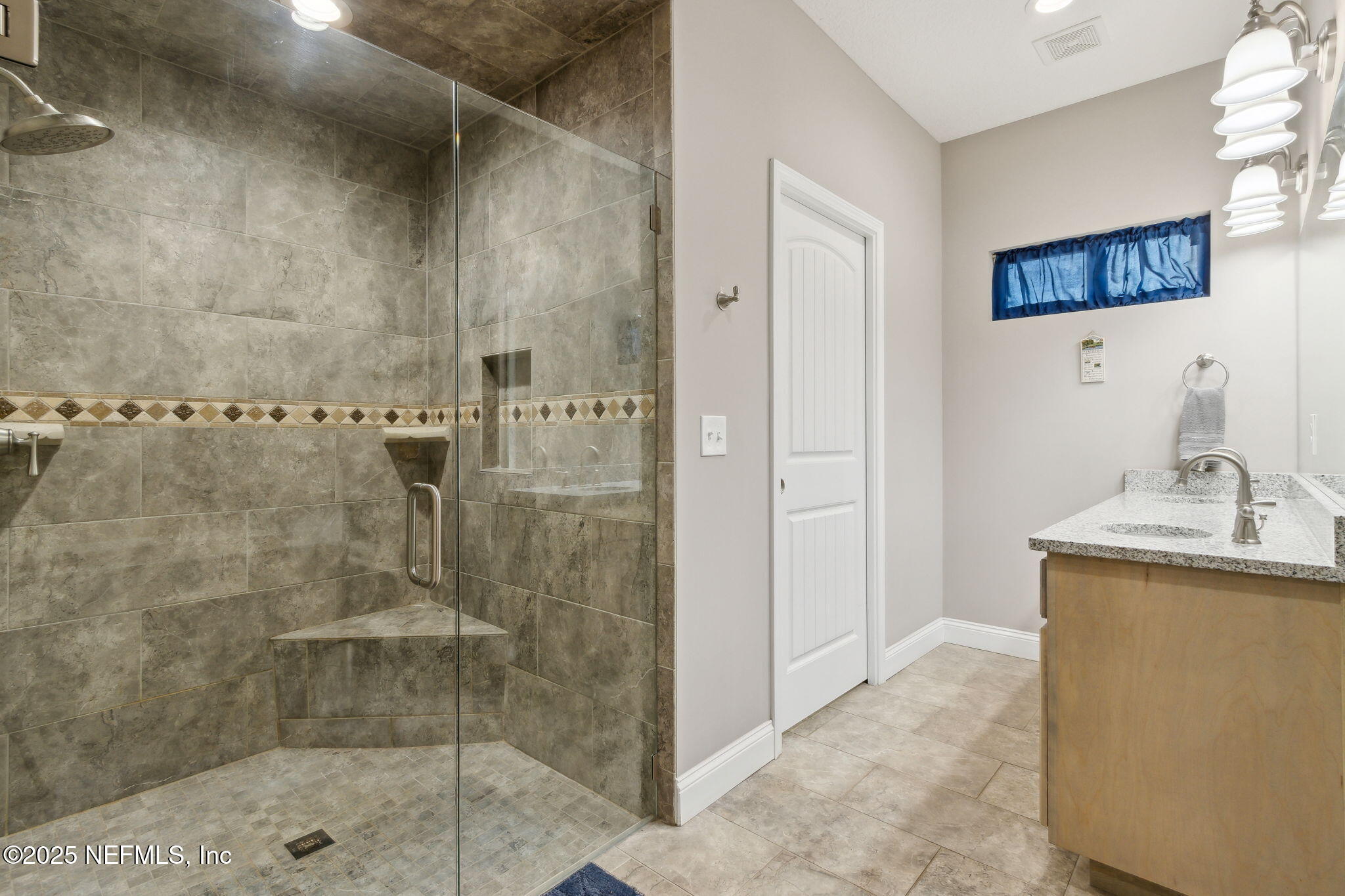 3303 Henry Lee Road Hilliard, FL 32046 - Photo 23 of 35 a bathroom with a shower and a sink