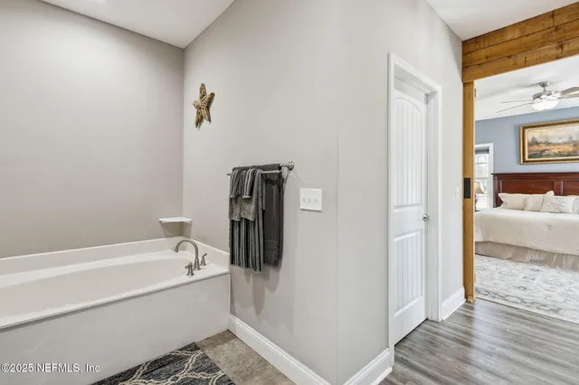 a bathroom with a tub and shower