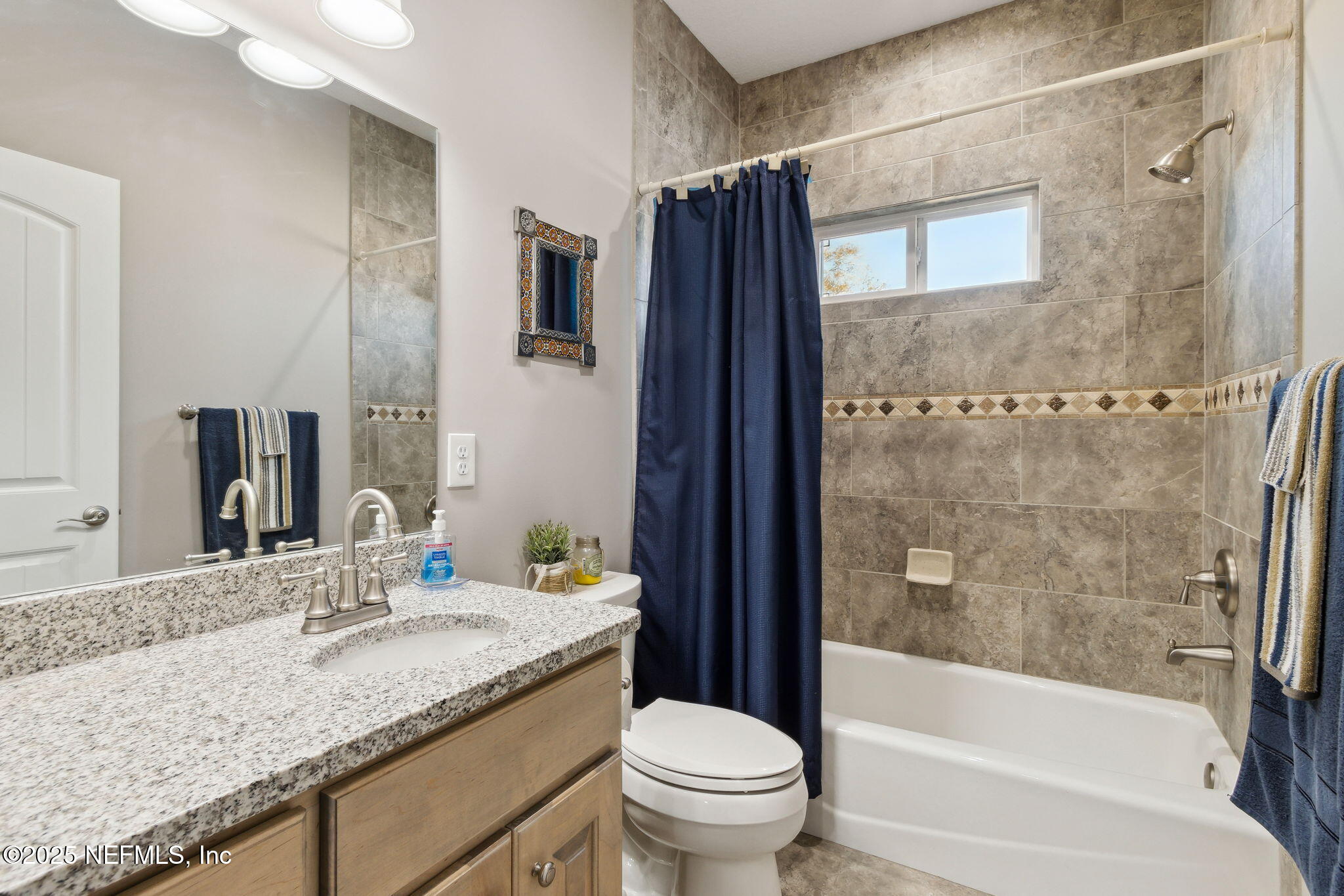 3303 Henry Lee Road Hilliard, FL 32046 - Photo 28 of 35 a bathroom with a granite countertop sink toilet and shower