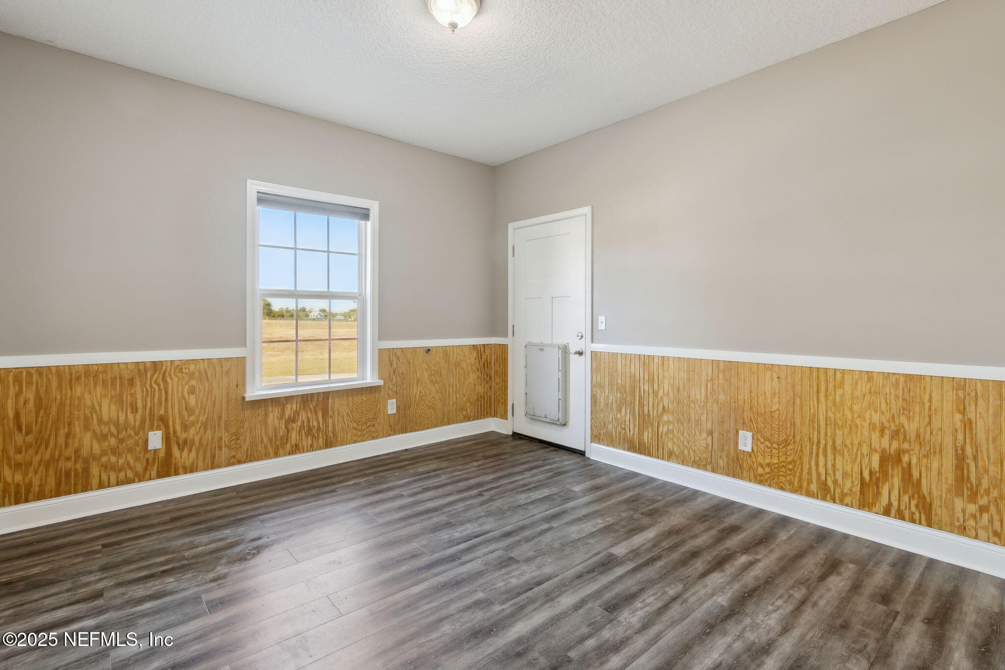 3303 Henry Lee Road Hilliard, FL 32046 - Photo 29 of 35 a view of an empty room with wooden floor and a window