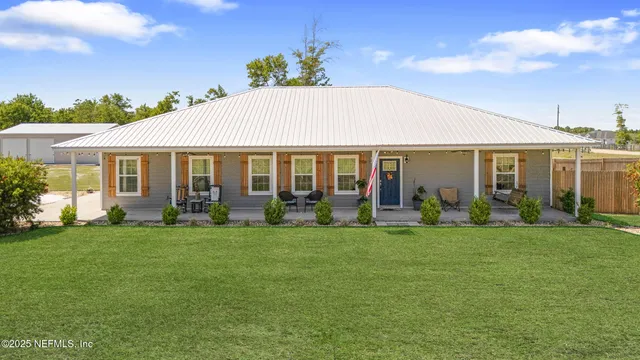 a front view of a house with a garden and porch
