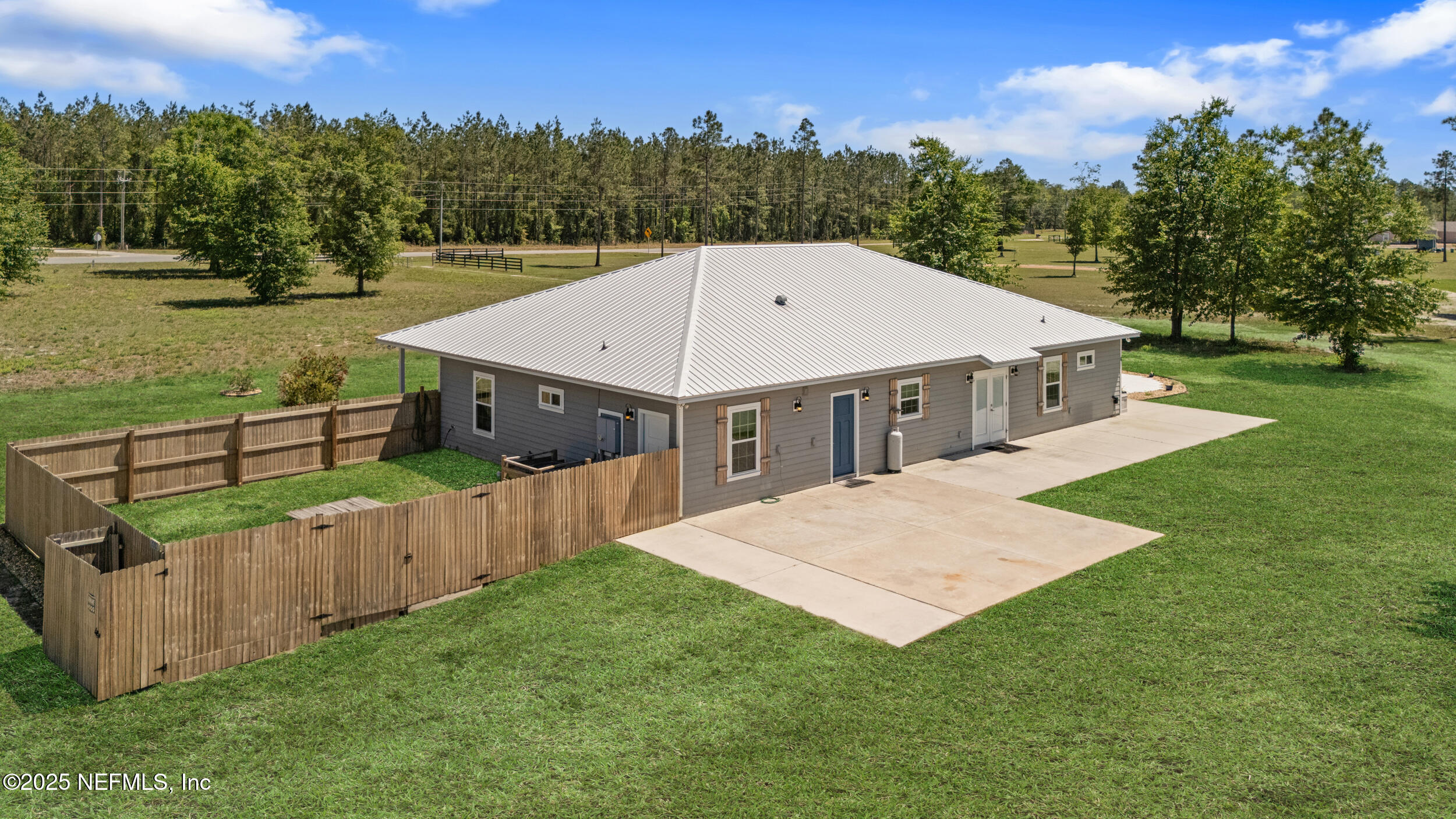 3303 Henry Lee Road Hilliard, FL 32046 - Photo 34 of 35 a view of a house with deck and a yard
