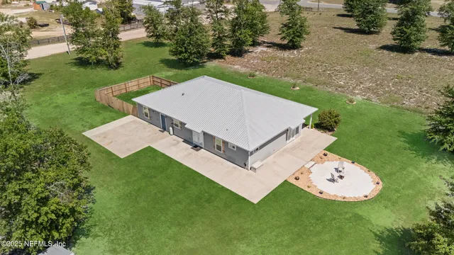 an aerial view of a house with backyard