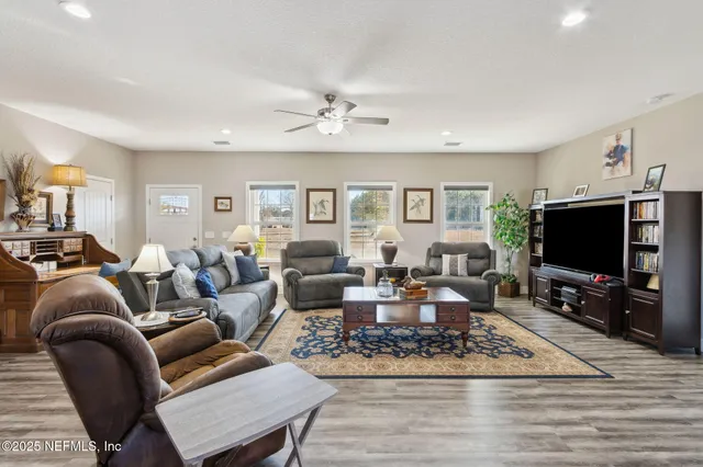a living room with furniture a rug and a flat screen tv