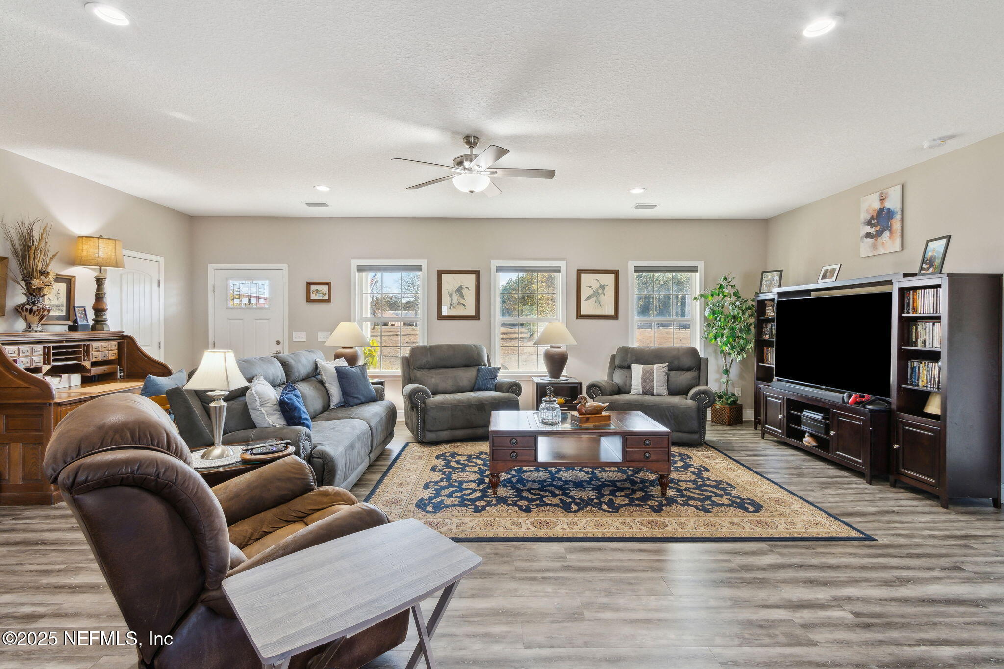 3303 Henry Lee Road Hilliard, FL 32046 - Photo 9 of 35 a living room with furniture a rug and a flat screen tv