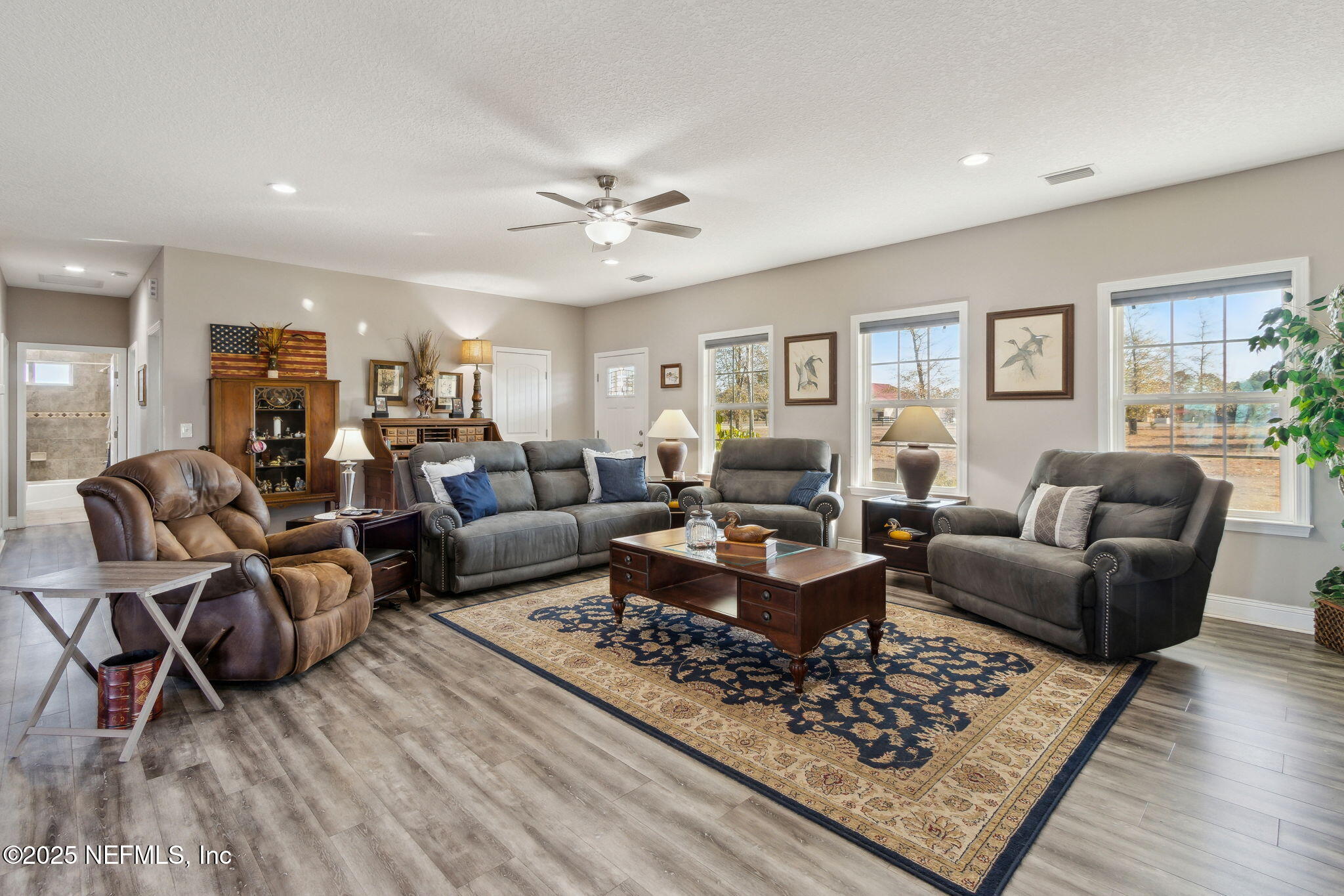 3303 Henry Lee Road Hilliard, FL 32046 - Photo 10 of 35 a living room with furniture a rug and a window