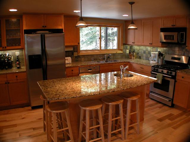 1116 Martis Landing Truckee, CA 96161 - Photo 2 of 7 a kitchen with stainless steel appliances granite countertop a stove a refrigerator a microwave a sink and chairs