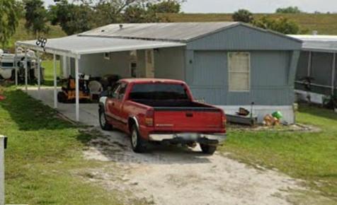 480 Highway 441, Unit 6 Okeechobee, FL 34974 - Photo 2 of 2 a car parked in front of a house