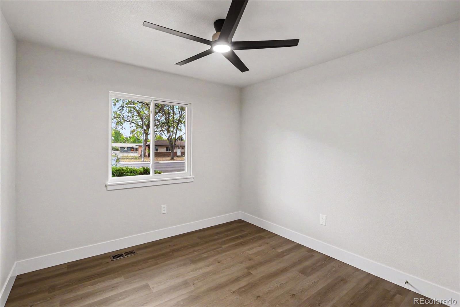 809 Gallup Road Fort Collins, CO 80521 - Photo 12 of 20 a view of an empty room with wooden floor and a window
