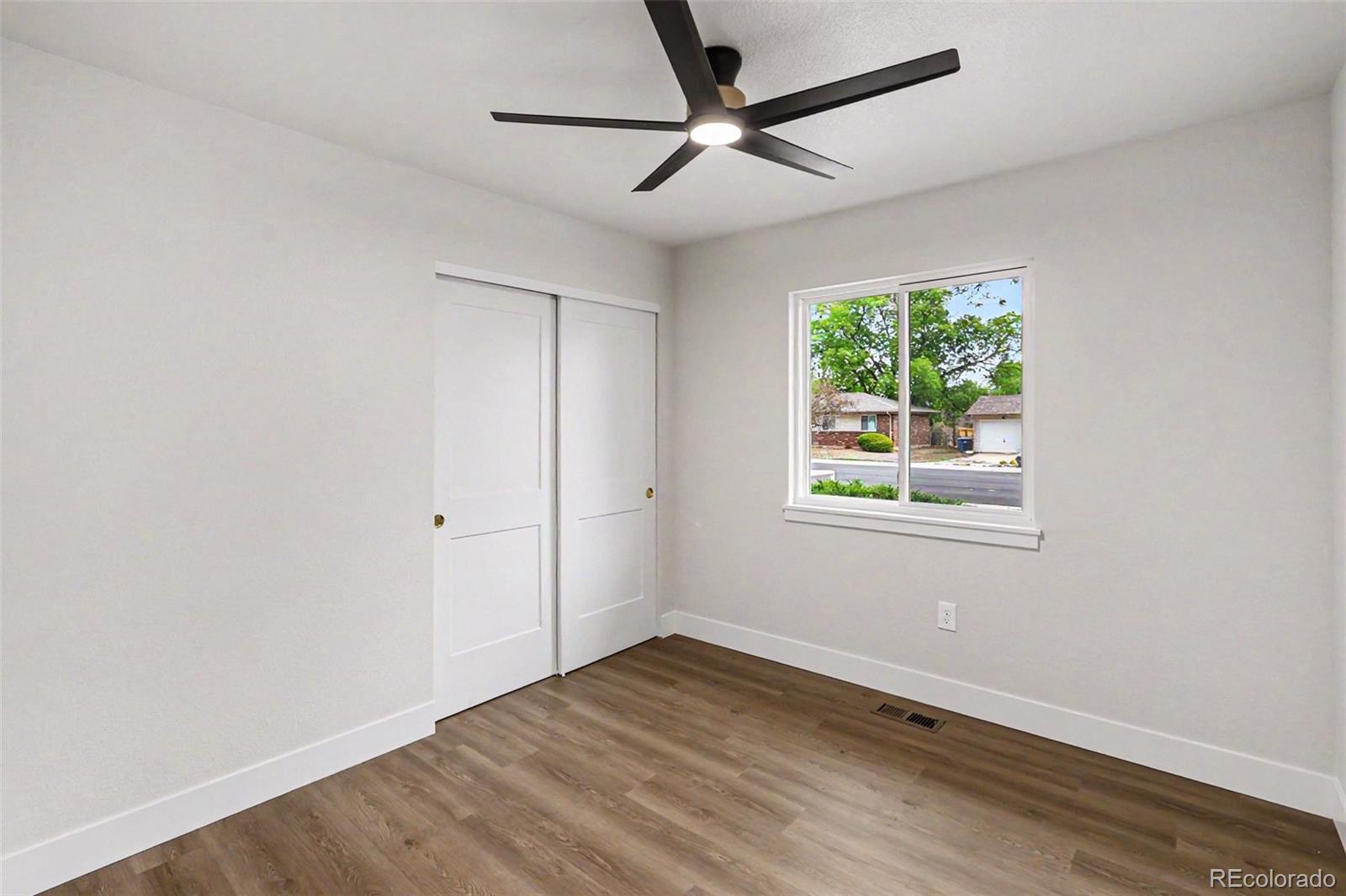 809 Gallup Road Fort Collins, CO 80521 - Photo 13 of 20 a view of empty room with wooden floor and fan
