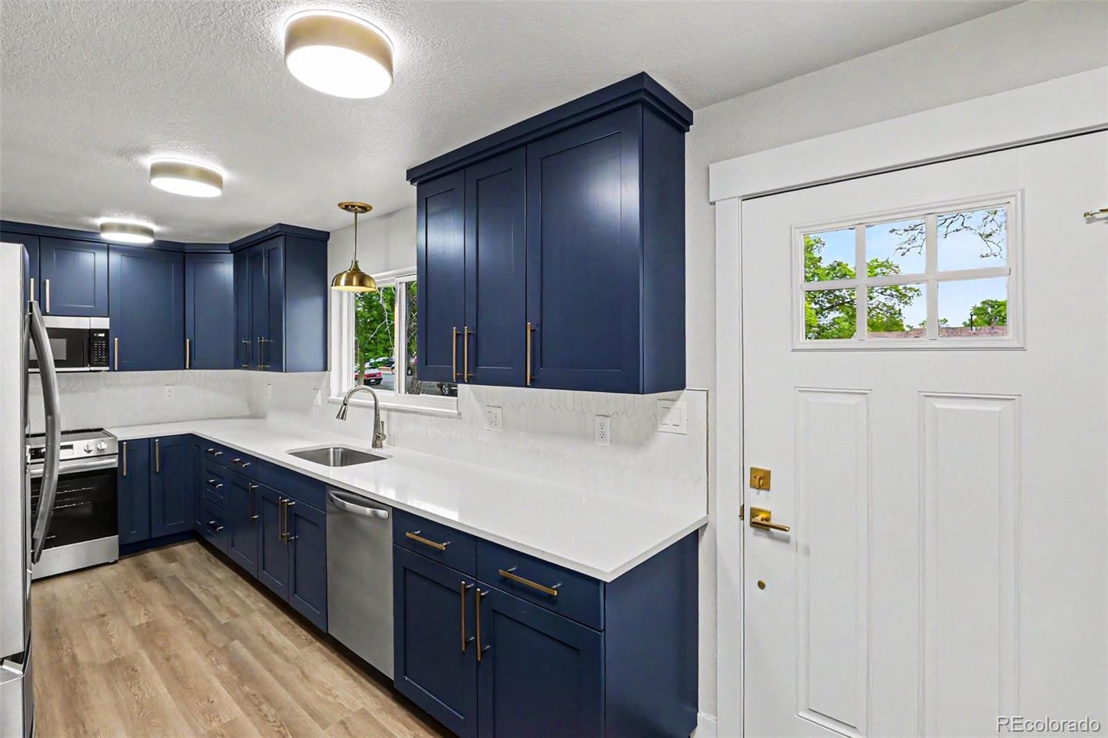 809 Gallup Road Fort Collins, CO 80521 - Photo 2 of 20 a kitchen with a sink and a refrigerator