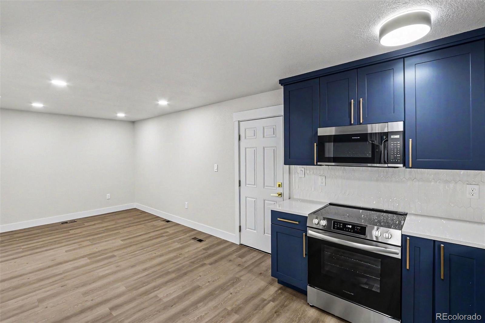 809 Gallup Road Fort Collins, CO 80521 - Photo 5 of 20 a kitchen with a stove and a microwave