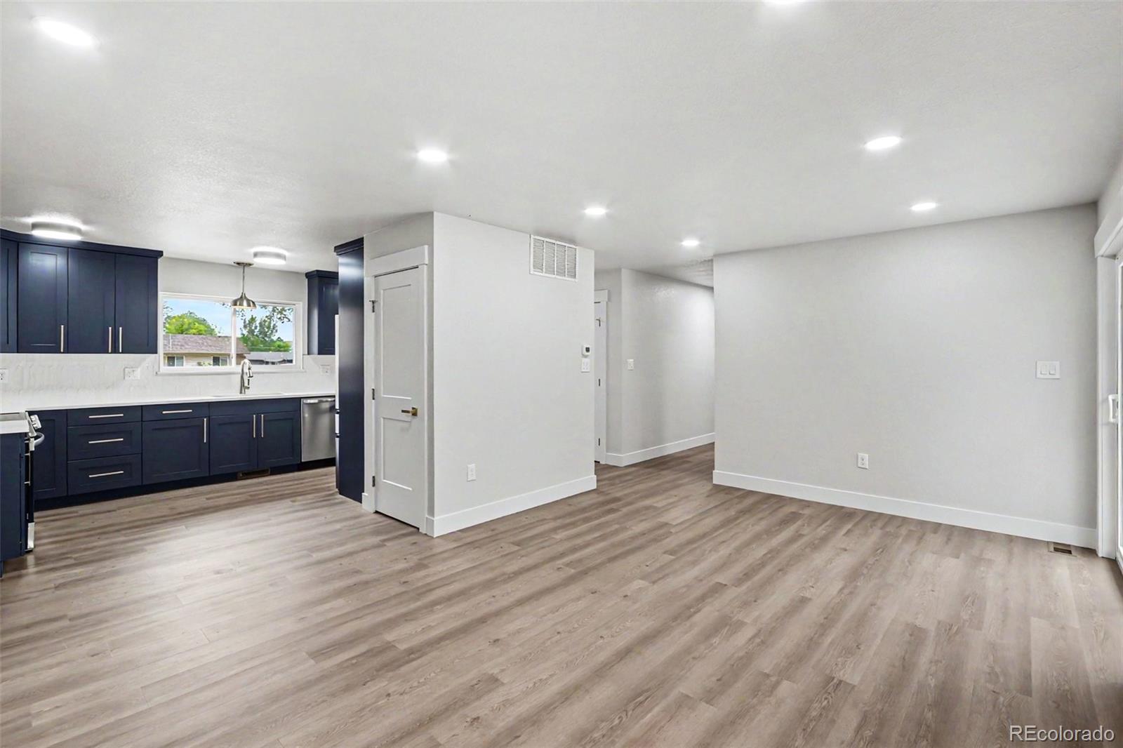 809 Gallup Road Fort Collins, CO 80521 - Photo 6 of 20 a view of kitchen and empty room with wooden floor