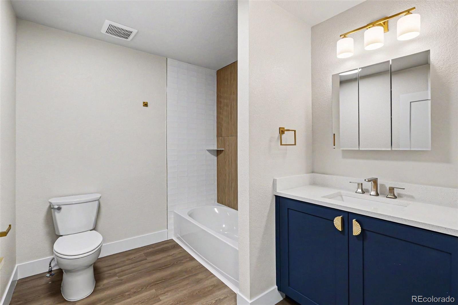 809 Gallup Road Fort Collins, CO 80521 - Photo 10 of 20 a bathroom with a granite countertop sink toilet and shower