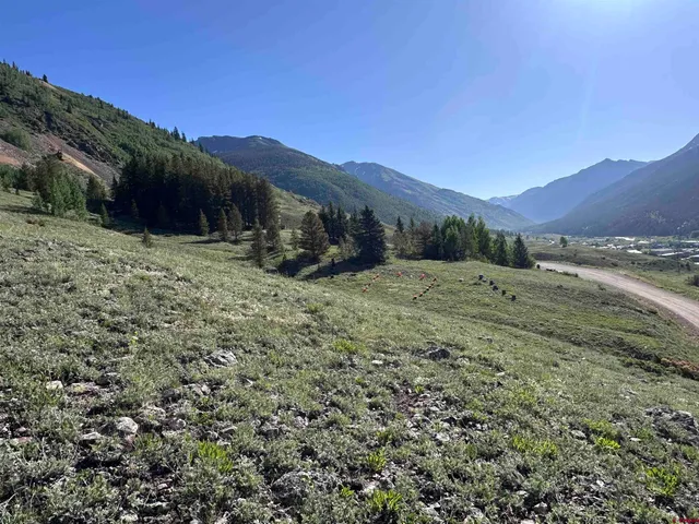 a view of a big house with a mountain in the background