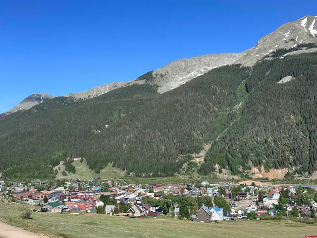 a view of a town with mountains in the background
