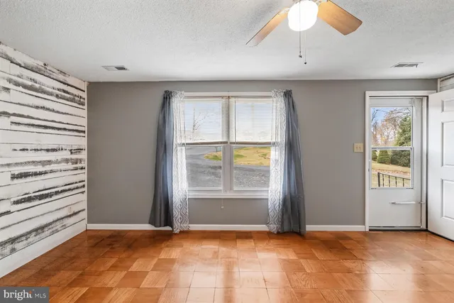 an empty room with windows and closet