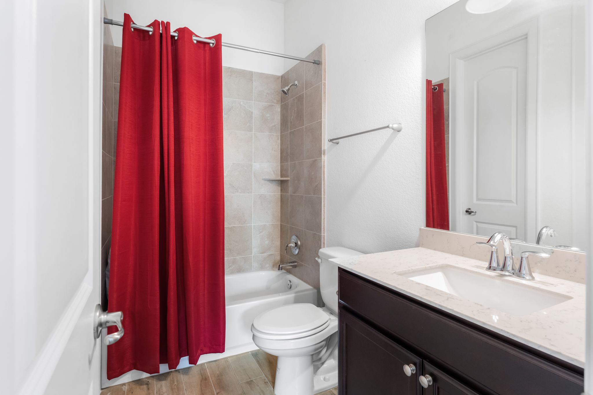 140 Waterloo Cove Georgetown, TX 78628 - Photo 29 of 40 A well-appointed bath features a tub with tiled surround, a vanity with a counter, and modern fixtures.