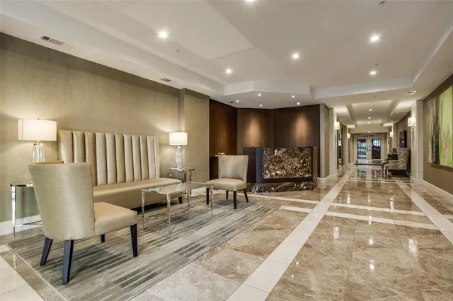 a lobby with furniture and a rug