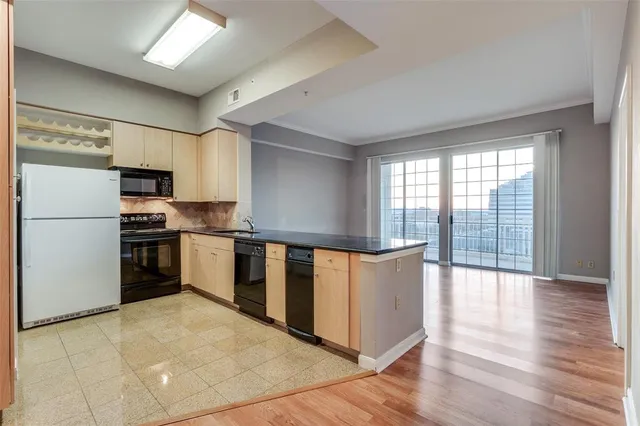 a kitchen with stainless steel appliances a refrigerator sink and cabinets