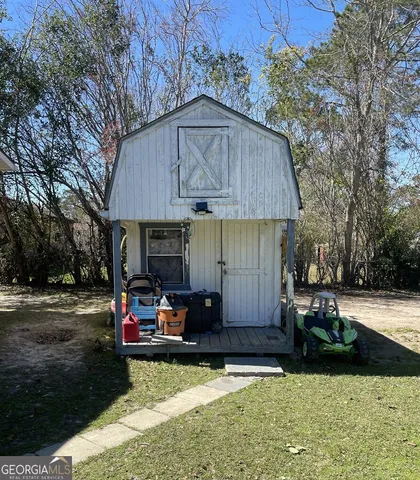 a view of a house with backyard and sitting area