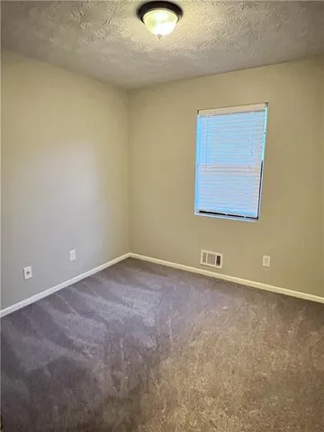 a view of room with wooden floor