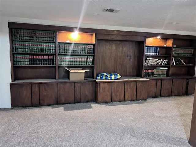 a front view of a house with a yard and tree