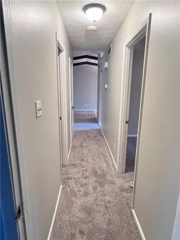 a view of empty room with a fireplace